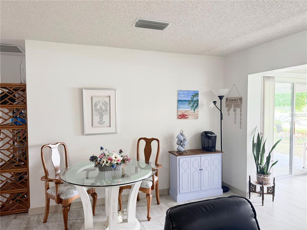 9394 Southwest 97th Lane, Unit A Ocala, FL 34481 - Photo 19 of 22 a view of a dining room with furniture and window