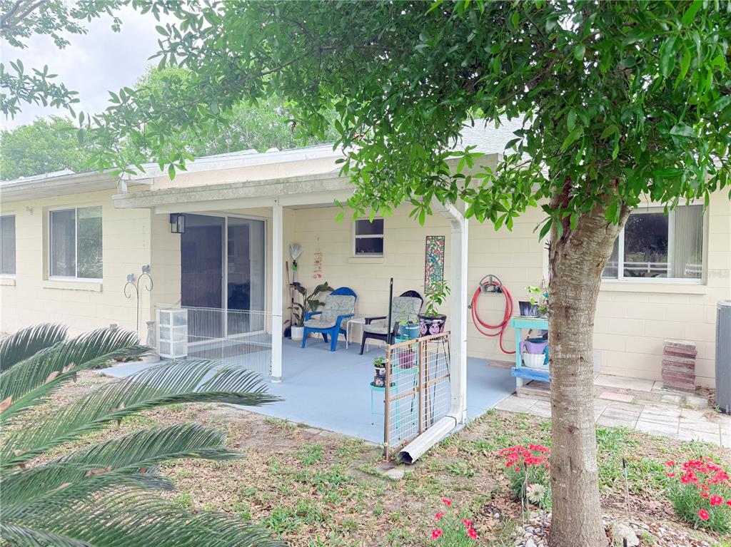 9394 Southwest 97th Lane, Unit A Ocala, FL 34481 - Photo 22 of 22 a view of a dinning table and chairs in patio of the house