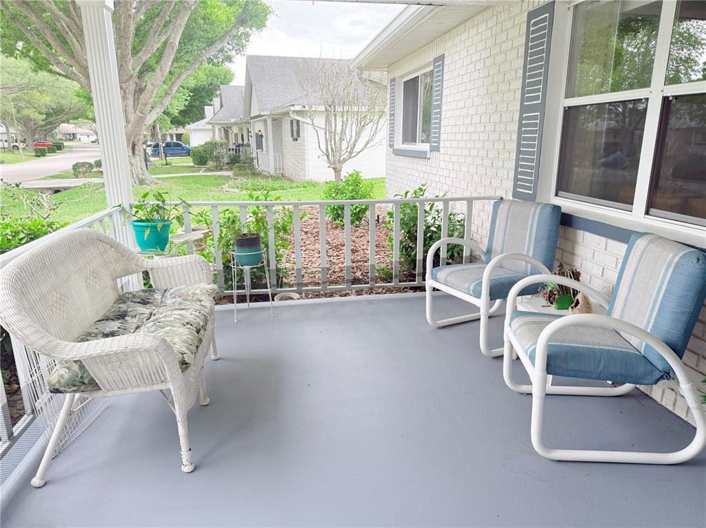 9394 Southwest 97th Lane, Unit A Ocala, FL 34481 - Photo 4 of 22 a balcony with table and chairs
