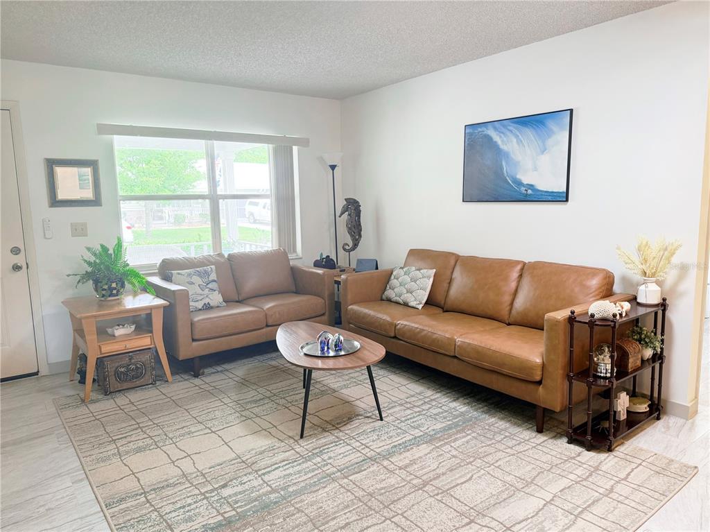 9394 Southwest 97th Lane, Unit A Ocala, FL 34481 - Photo 5 of 22 a living room with furniture and a large window