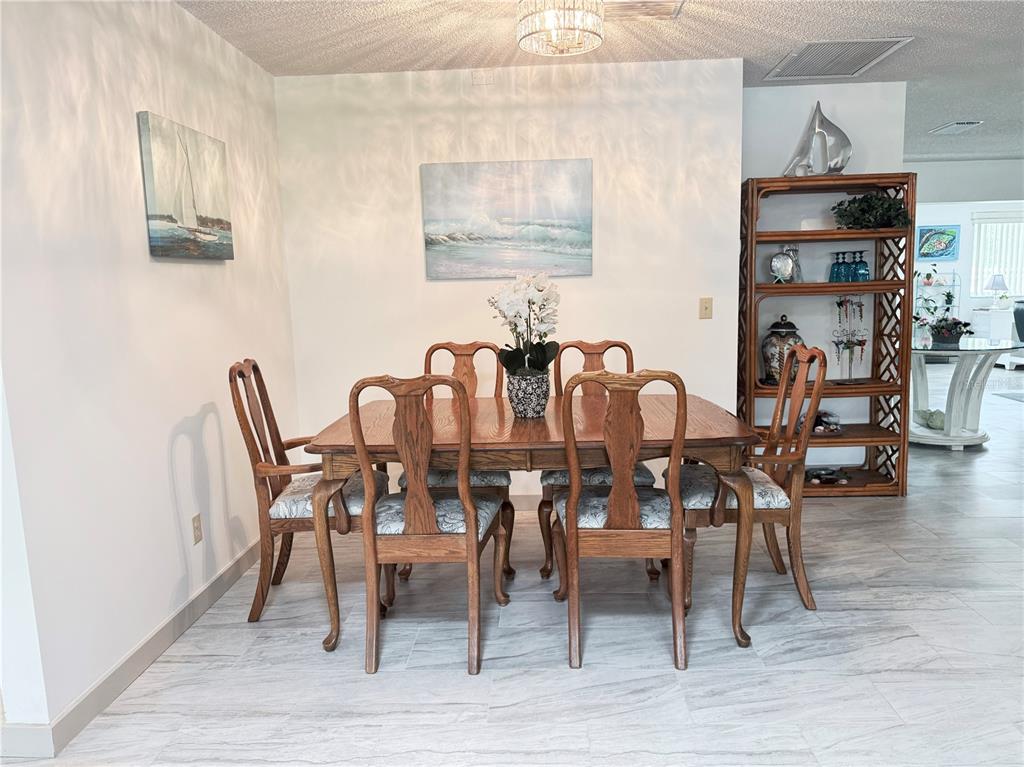 9394 Southwest 97th Lane, Unit A Ocala, FL 34481 - Photo 7 of 22 a view of a dining room with furniture and wooden floor