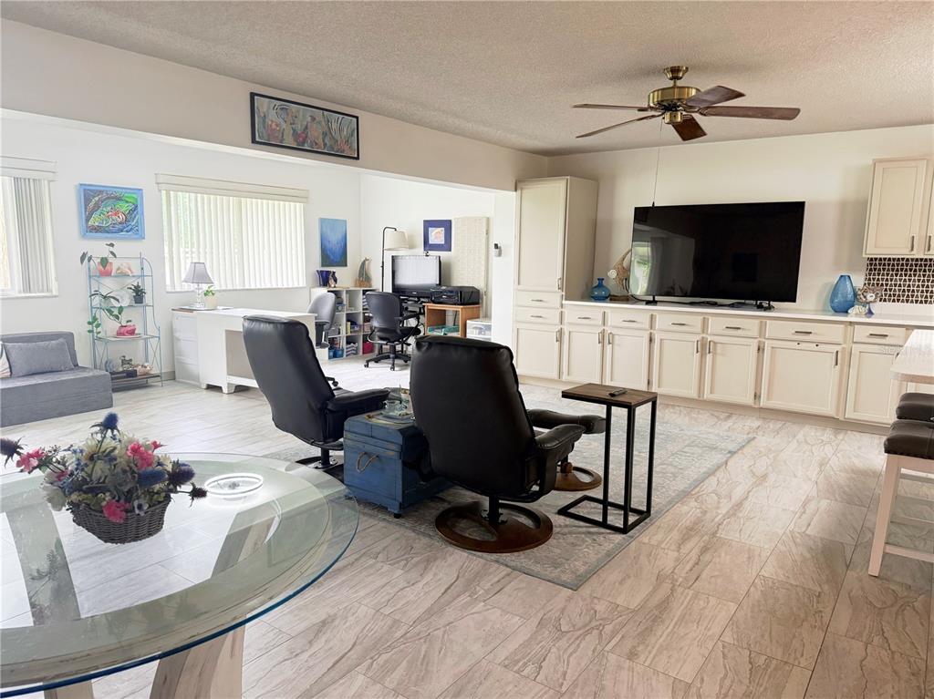 9394 Southwest 97th Lane, Unit A Ocala, FL 34481 - Photo 10 of 22 a view of a livingroom with furniture a flat screen tv and a window