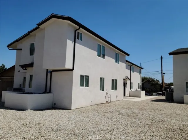a view of a house with wooden fence