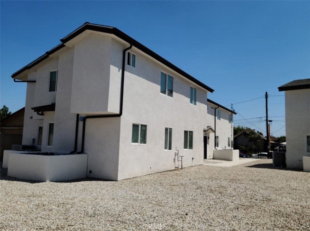 a view of a house with wooden fence