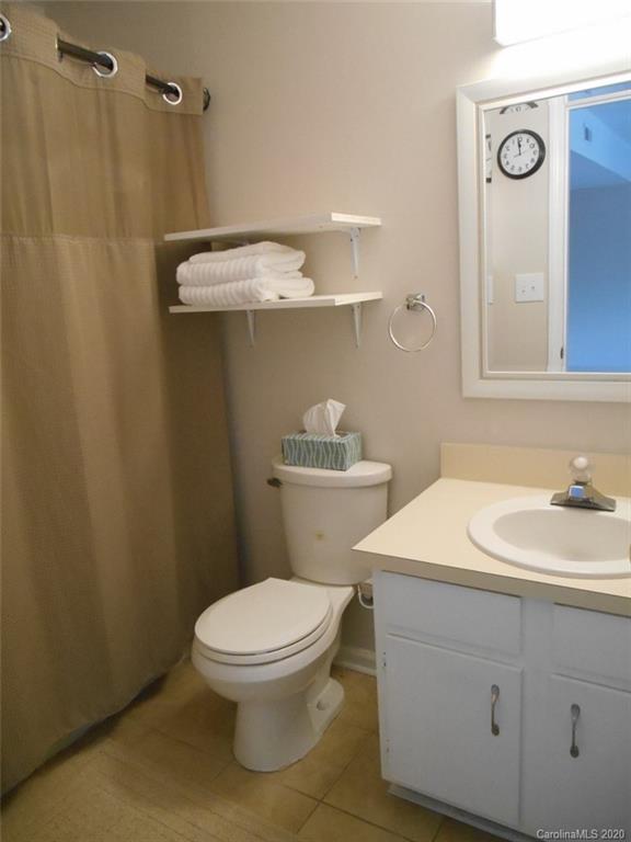 11183 Harrowfield Road Charlotte, NC 28226 - Photo 14 of 20 a bathroom with a sink a toilet and shower