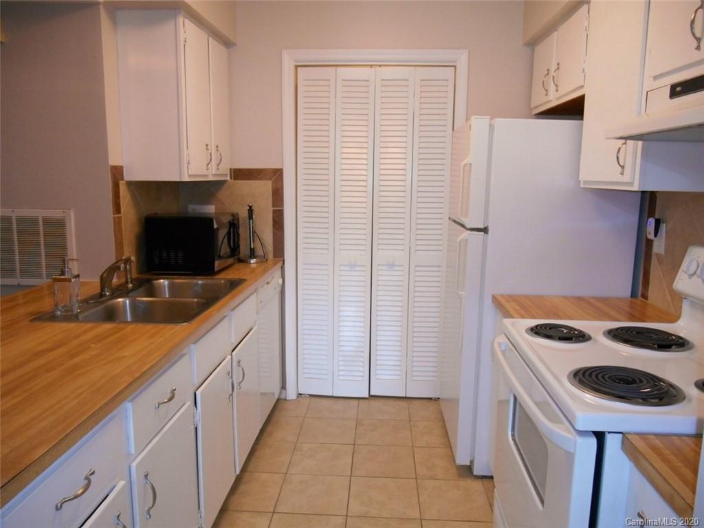 11183 Harrowfield Road Charlotte, NC 28226 - Photo 9 of 20 a kitchen with stainless steel appliances a stove a sink and a refrigerator