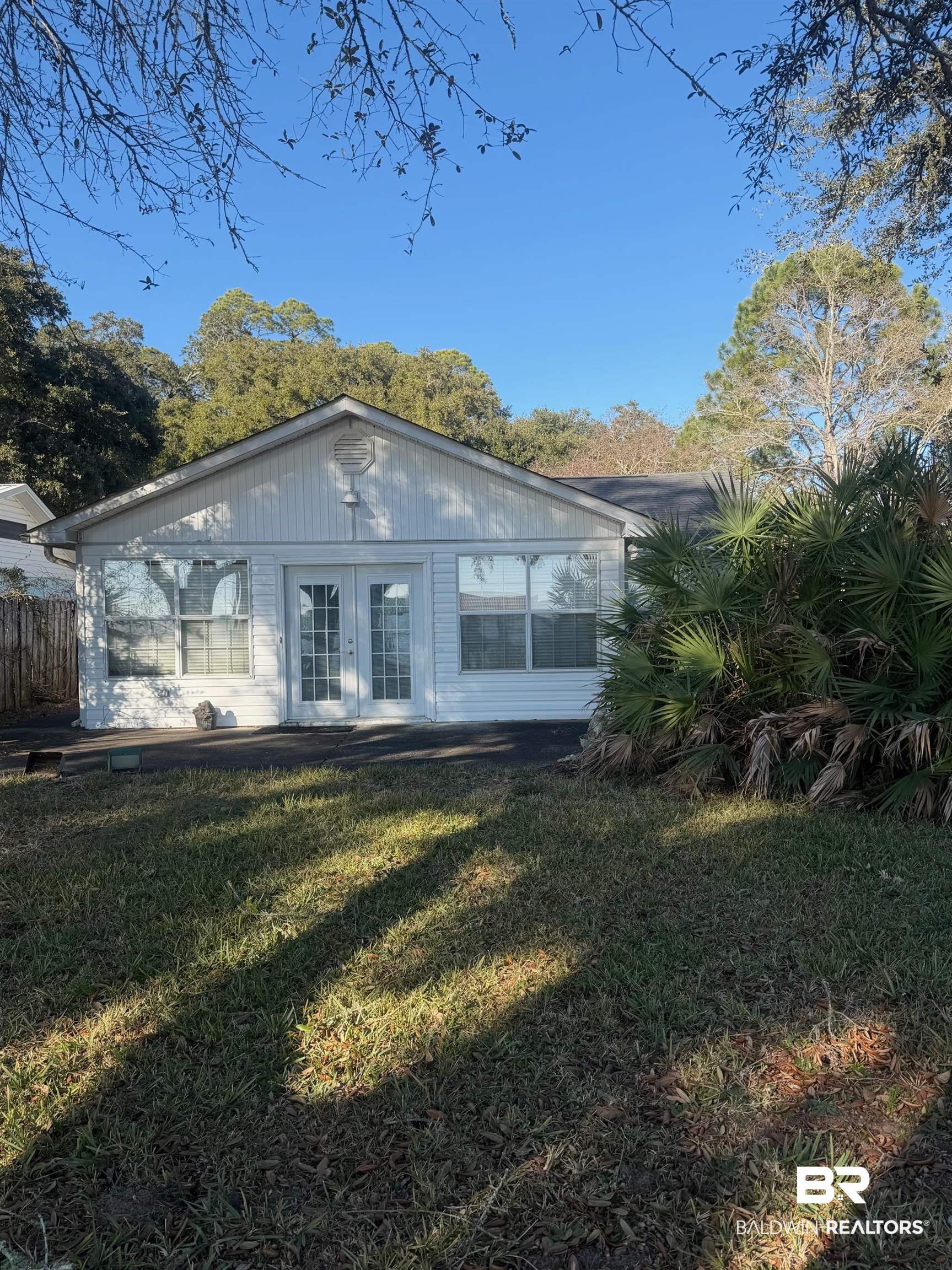 35776 Boykin Boulevard Lillian, AL 36549 - Photo 2 of 14 Back of property featuring french doors and a lawn