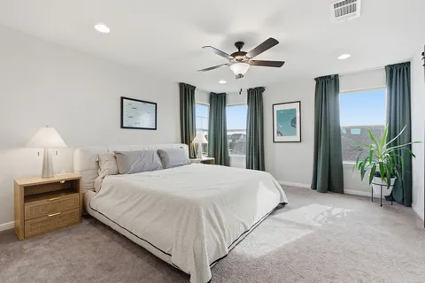 a bedroom with a bed and a chandelier