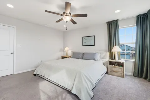 a bedroom with a bed furniture and a large window