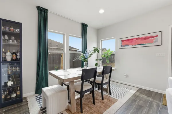 a view of a dining room with furniture and window