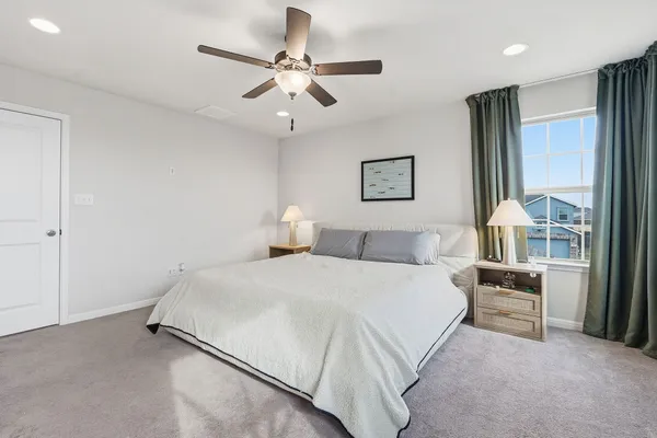 a bedroom with a bed furniture and a large window