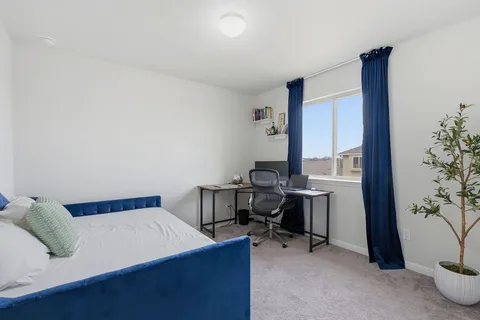 a bedroom with a bed and a potted plant