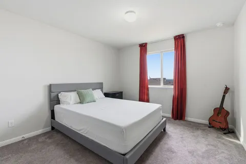 a bedroom with a bed and a lamp