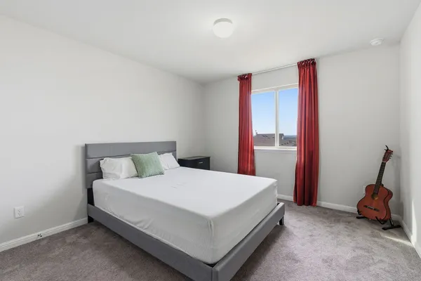 a bedroom with a bed and a lamp