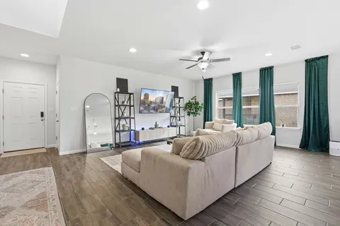 a living room with furniture and a large window
