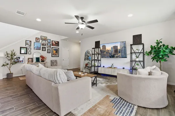 a living room with furniture and wooden floor