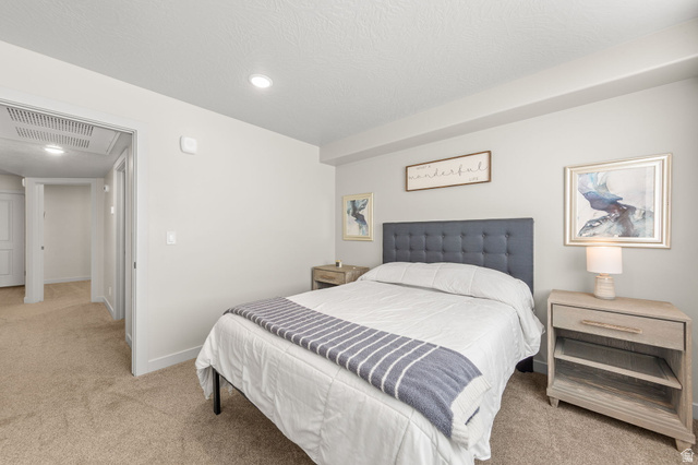 6231 Winding Way, Unit K105 Hurricane, UT 84737 - Photo 11 of 20 Bedroom featuring light colored carpet and baseboards