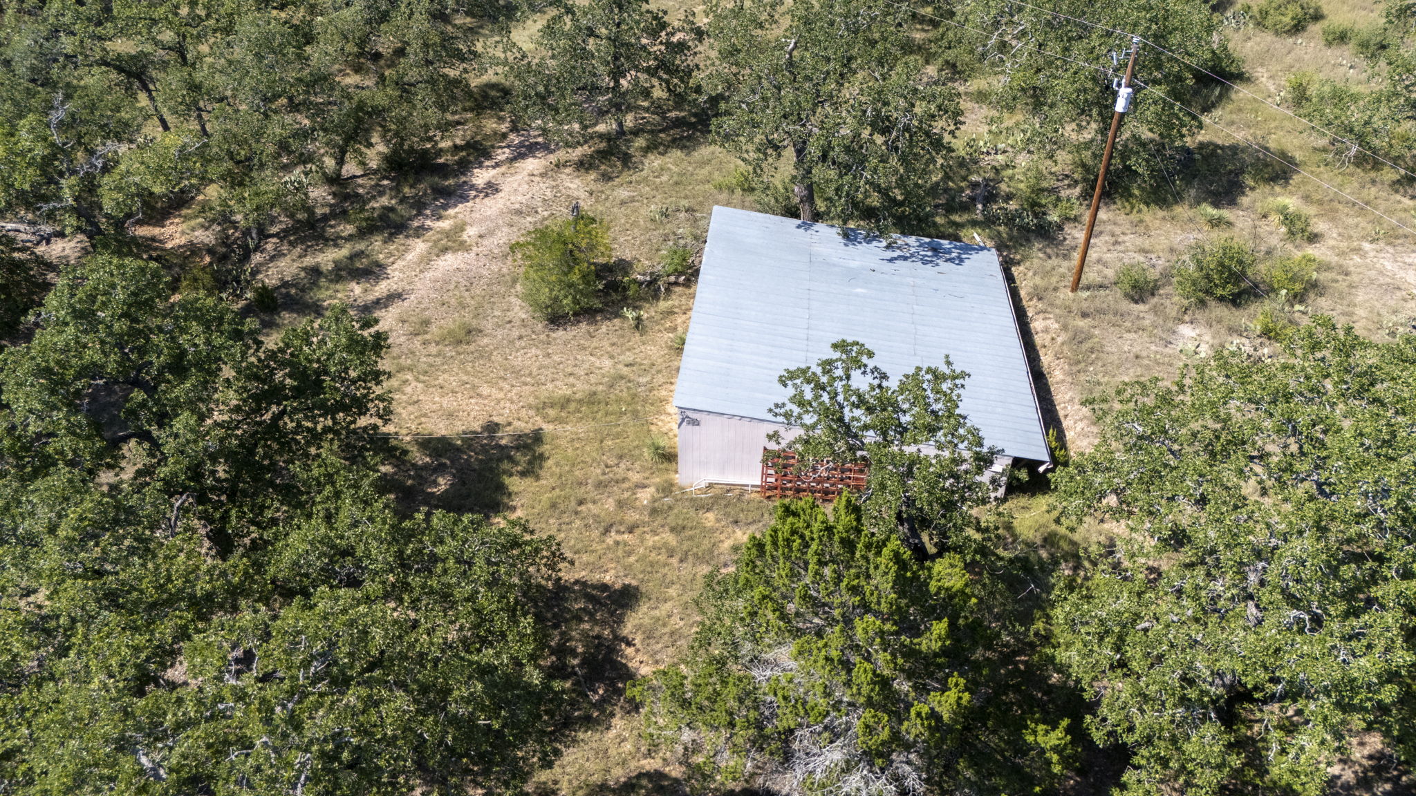 Tbd Singleton Road Marble Falls, TX 78654 - Photo 39 of 40 an aerial view of a house with a yard and large trees