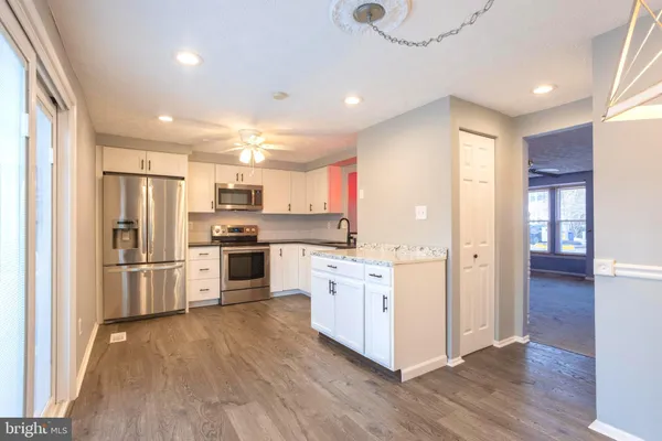 a kitchen with stainless steel appliances a refrigerator and a stove top oven