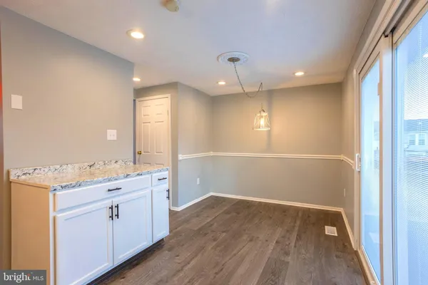 a bathroom with a sink a toilet a large mirror and shower