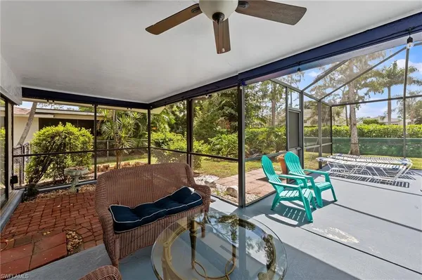 a view of yard from deck with patio