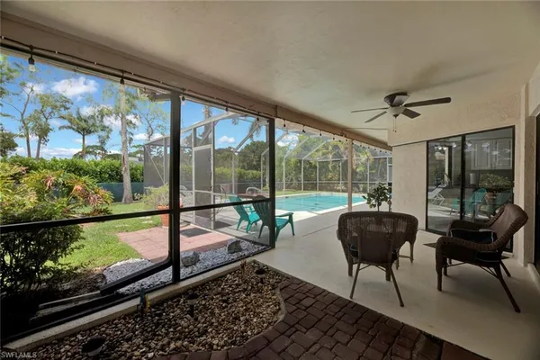 a view of a swimming pool with a patio and a yard