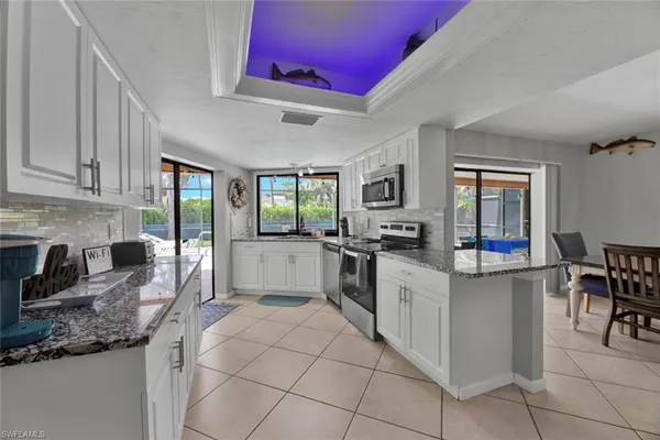 a kitchen with a stove top oven and cabinets
