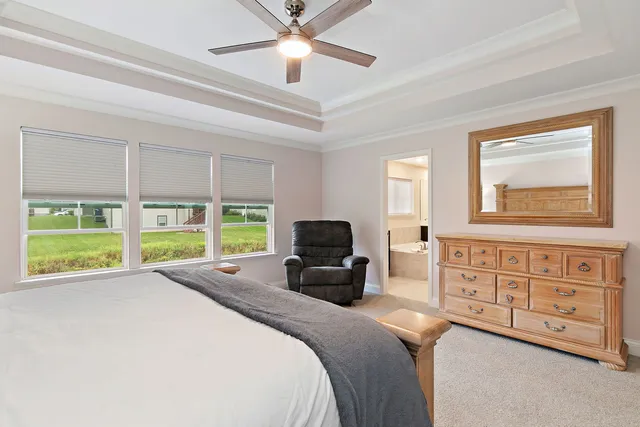 a bedroom with a bed and a large window with the outer view