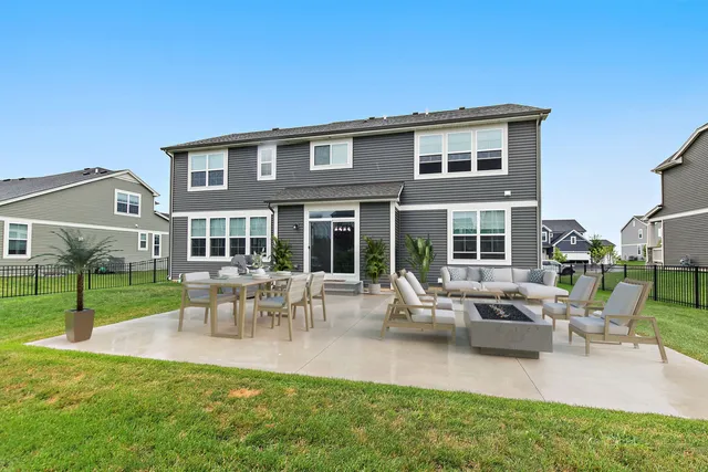 a view of a house with a backyard and a patio