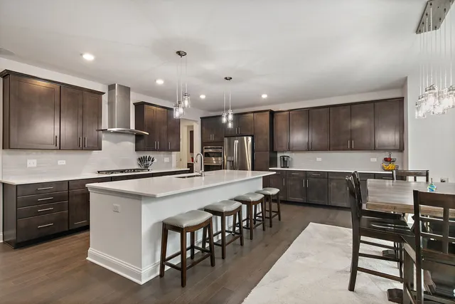 a large kitchen with a table and chairs