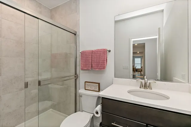 a bathroom with a sink toilet a mirror and shower