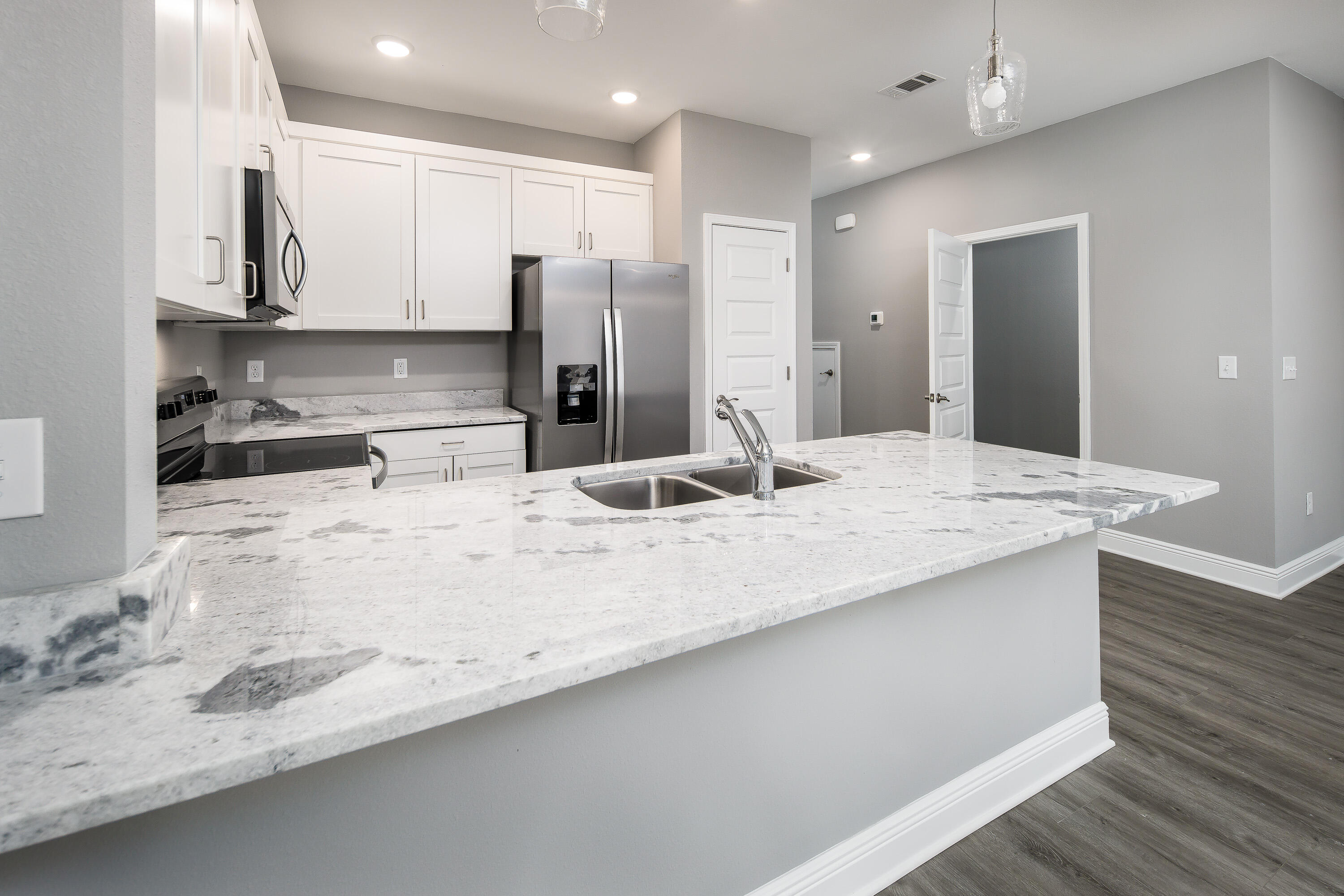 969 Skylark Road Mary Esther, FL 32569 - Photo 6 of 31 a view of a kitchen with kitchen island a sink stainless steel appliances and cabinets