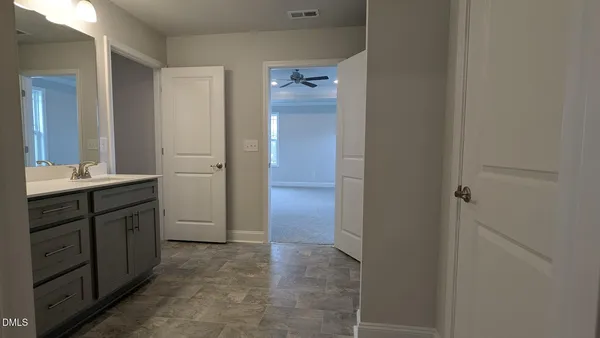 a view of an empty room and closet area