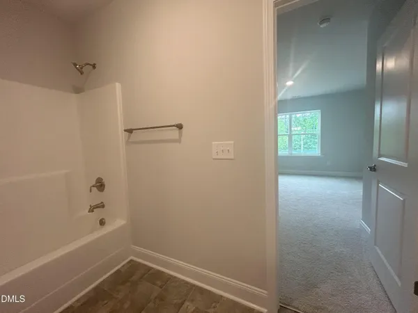 an empty room with closet and a bathroom