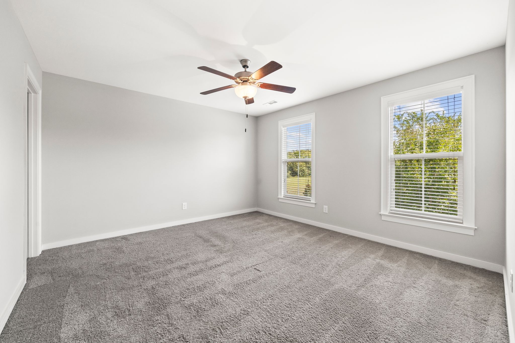 5001 Ryecroft Lane Franklin, TN 37064 - Photo 12 of 19 an empty room with windows and fan chandelier fan