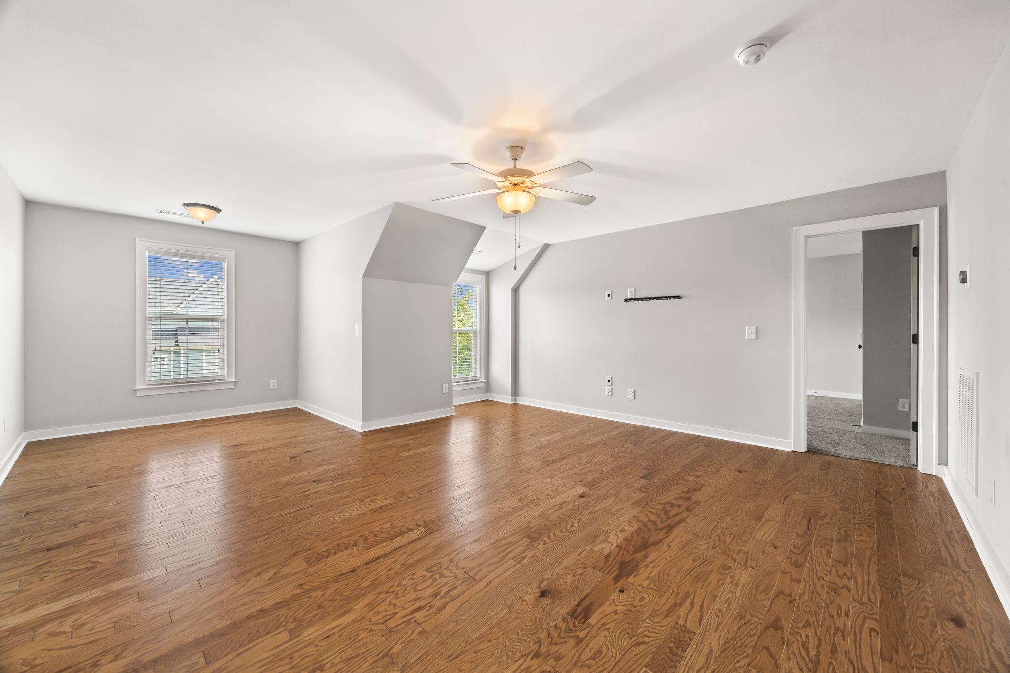 5001 Ryecroft Lane Franklin, TN 37064 - Photo 13 of 19 an empty room with wooden floor chandelier fan and windows
