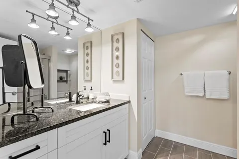 a bathroom with a double vanity sink and a mirror