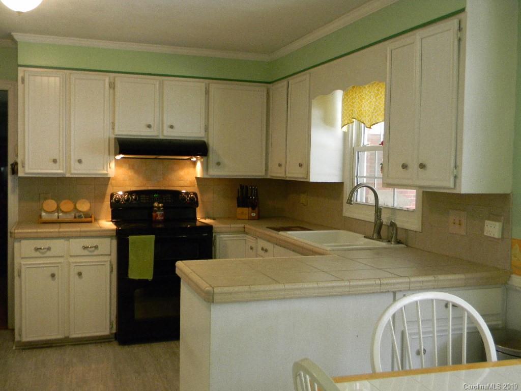 416 Willow Road Salisbury, NC 28147 - Photo 5 of 19 a kitchen with a stove a sink and a cabinets