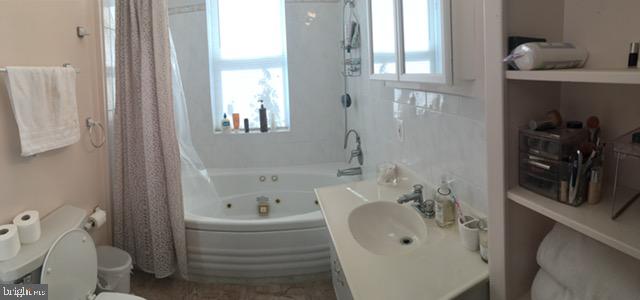 922 O Street Northwest, Unit 1 Washington, DC 20001 - Photo 2 of 8 a bathroom with a sink a toilet and shower