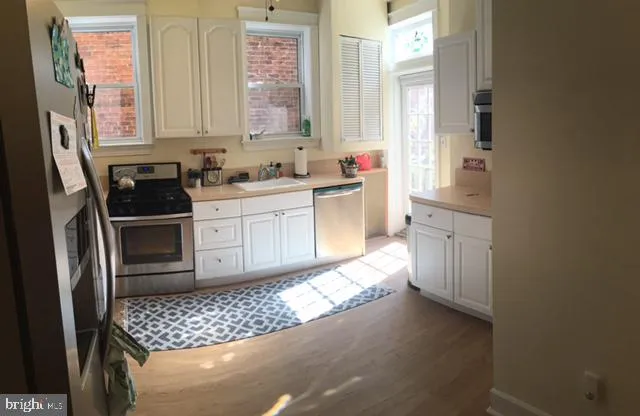 a kitchen with stainless steel appliances a refrigerator and a sink