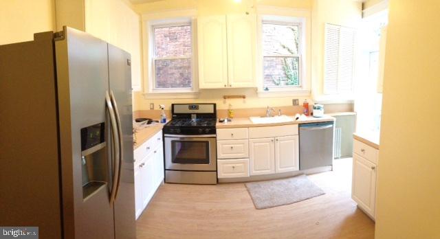922 O Street Northwest, Unit 1 Washington, DC 20001 - Photo 6 of 8 a kitchen with stainless steel appliances a refrigerator sink and stove