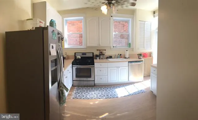 a kitchen with stainless steel appliances a refrigerator and a sink