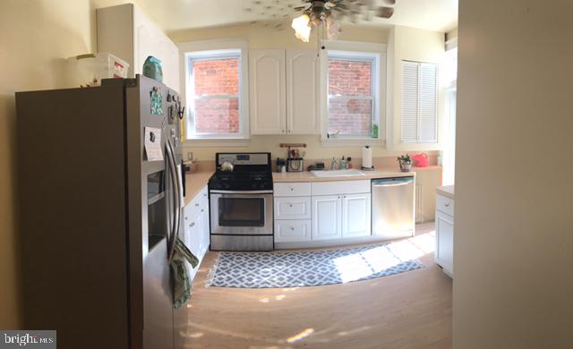 922 O Street Northwest, Unit 1 Washington, DC 20001 - Photo 7 of 8 a kitchen with stainless steel appliances a refrigerator and a sink