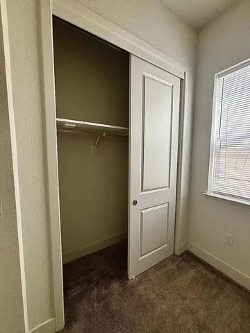 a bathroom with a sink a toilet a mirror and shower