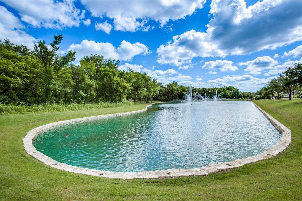1006 Emil Place Allen, TX 75013 - Photo 25 of 28 Expansive water feature with multiple fountains and a stone-lined border