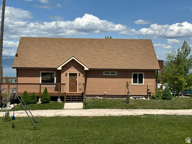 12 Crook Street Fish Haven, ID 83287 - Photo 5 of 35 View of front of home featuring a shingled roof and a front lawn