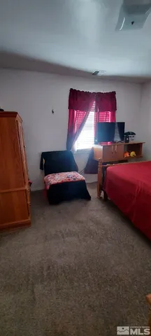 a bedroom with bed and window