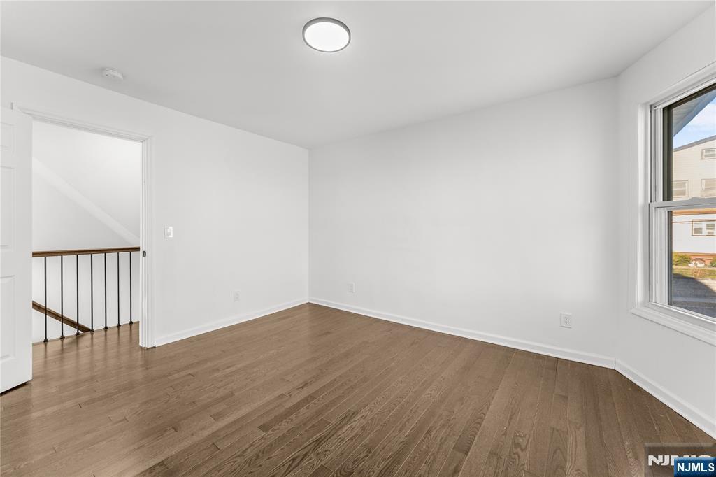 96 Prospect Terrace East Rutherford, NJ 07073 - Photo 11 of 31 an empty room with wooden floor and windows