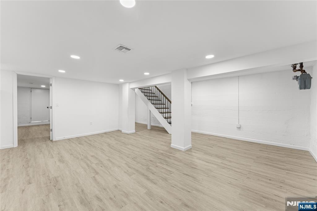 96 Prospect Terrace East Rutherford, NJ 07073 - Photo 21 of 31 an empty room with wooden floor and staircase