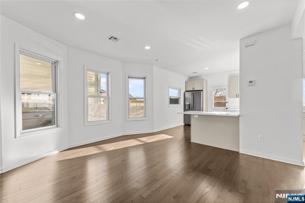 96 Prospect Terrace East Rutherford, NJ 07073 - Photo 6 of 31 a view of an empty room with wooden floor and a window